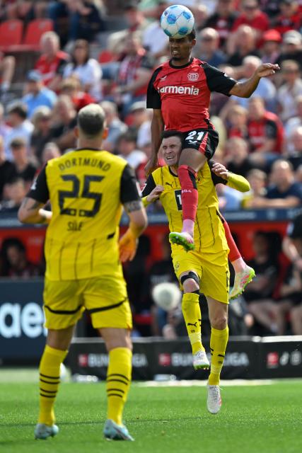 (250512) -- LEVERKUSEN, May 12, 2025 (Xinhua) -- Amine Adli (top) of Bayer 04 Leverkusen and Pascal Gross of Borussia Dortmund head for the ball during the first division of Bundesliga football match between Bayer 04 Leverkusen and Borussia Dortmund in Leverkusen, Germany, May 11, 2025. (Photo by Ulrich Hufnagel/Xinhua)