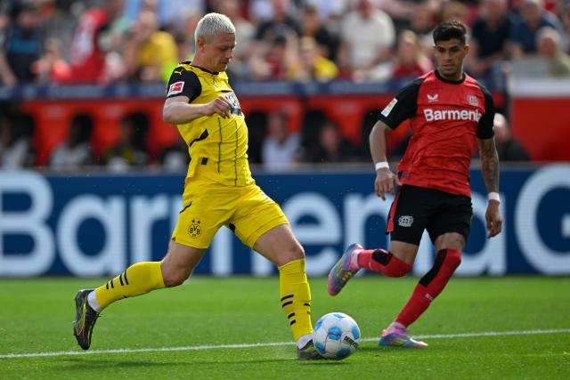 (250512) -- LEVERKUSEN, May 12, 2025 (Xinhua) -- Piero Hincapie (R) of Bayer 04 Leverkusen vies with Julian Ryerson of Borussia Dortmund during the first division of Bundesliga football match between Bayer 04 Leverkusen and Borussia Dortmund in Leverkusen, Germany, May 11, 2025. (Photo by Ulrich Hufnagel/Xinhua)