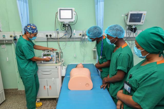 (250512) -- DAR ES SALAAM, May 12, 2025 (Xinhua) -- Zhang Junqiao (1st L), leader of the 27th Chinese medical team in Tanzania, instructs local Tanzanian nurses to learn first aid knowledge in Dar es Salaam, Tanzania, May 9, 2025.
  TO GO WITH "Feature: Chinese doctor empowers Tanzanian nurses with advanced medical skills and beyond" (Xinhua/Emmanuel Herman)