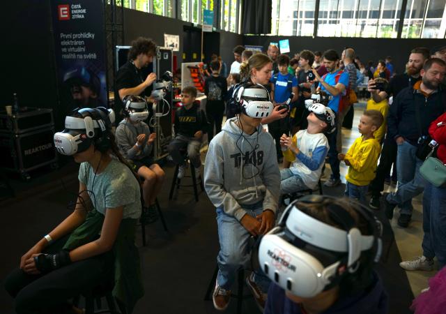 (250512) -- PRAGUE, May 12, 2025 (Xinhua) -- Children take part in a virtual tour of the power plant during the Maker Faire Prague 2025 in Prague, the Czech Republic, May 11, 2025.
  The two-day creativity show highlights a combination of modern technology and traditional craftsmanship. (Photo by Dana Kesnerova/Xinhua)