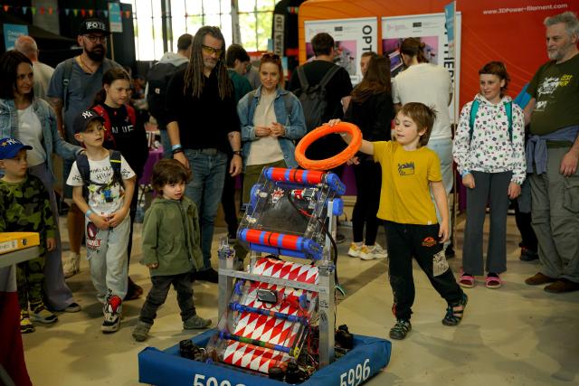 (250512) -- PRAGUE, May 12, 2025 (Xinhua) -- A boy inserts a rubber ring into a robot during the Maker Faire Prague 2025 in Prague, the Czech Republic, May 11, 2025.
  The two-day creativity show highlights a combination of modern technology and traditional craftsmanship. (Photo by Dana Kesnerova/Xinhua)