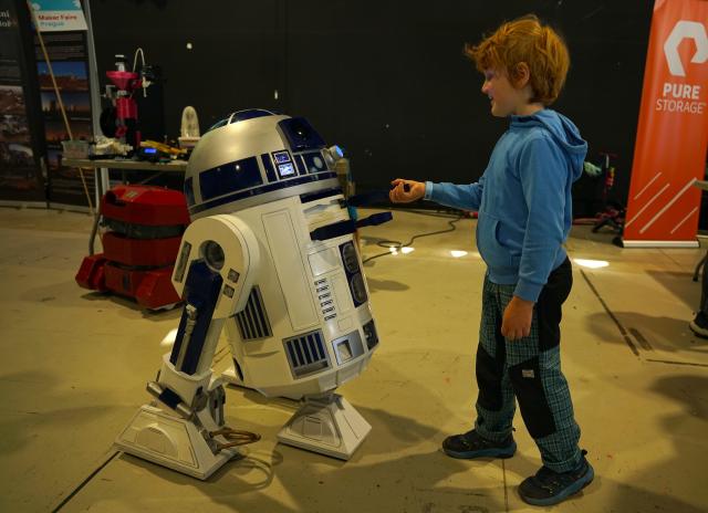 (250512) -- PRAGUE, May 12, 2025 (Xinhua) -- A boy interacts with a robot during the Maker Faire Prague 2025 in Prague, the Czech Republic, May 11, 2025.
  The two-day creativity show highlights a combination of modern technology and traditional craftsmanship. (Photo by Dana Kesnerova/Xinhua)