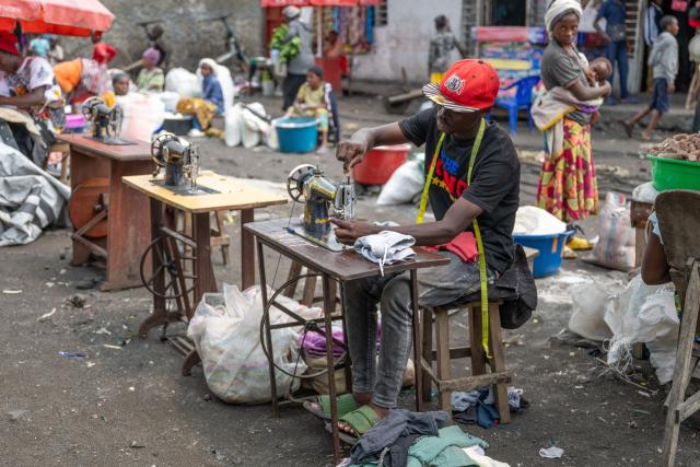 (250512) -- SAKE, May 12, 2025 (Xinhua) -- A resident sews clothes for customers at a local market in Sake, a small town located 27 kilometers from Goma, the capital city of North Kivu province in the Democratic Republic of the Congo (DRC), May 11, 2025.
  Many residents of Sake were forced to flee their homes due to attacks by the rebel group known as M23. Though life is gradually returning to normal as they return home, they now face significant challenges such as damaged infrastructure and shortages of basic supplies. (Xinhua/Zheng Yangzi)