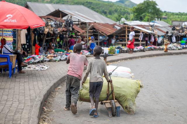 (250512) -- SAKE, May 12, 2025 (Xinhua) -- Two children transport goods at a local market in Sake, a small town located 27 kilometers from Goma, the capital city of North Kivu province in the Democratic Republic of the Congo (DRC), May 11, 2025.
  Many residents of Sake were forced to flee their homes due to attacks by the rebel group known as M23. Though life is gradually returning to normal as they return home, they now face significant challenges such as damaged infrastructure and shortages of basic supplies. (Xinhua/Zheng Yangzi)