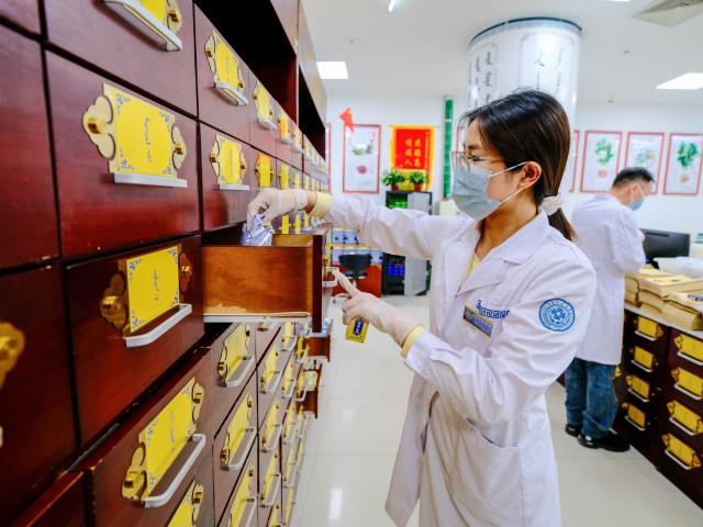 (250512) -- HOHHOT, May 12, 2025 (Xinhua) -- A pharmacist dispenses medicine at the Mongolian medicine room of the International Mongolian Hospital of Inner Mongolia in Hohhot, north China's Inner Mongolia Autonomous Region, May 12, 2025. The nurses of the hospital were busy at their posts on the International Nurse Day. By combining traditional Mongolian medical practices such as tea, wine and moxibustion with contemporary nursing methods, they offer patients nursing services that embodies ethnic medicine characteristics. (Xinhua/Ma Jinrui)