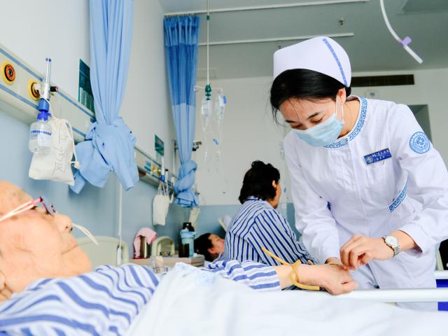(250512) -- HOHHOT, May 12, 2025 (Xinhua) -- A nurse applies an intravenous drip to a patient at the International Mongolian Hospital of Inner Mongolia in Hohhot, north China's Inner Mongolia Autonomous Region, May 12, 2025. The nurses of the hospital were busy at their posts on the International Nurse Day. By combining traditional Mongolian medical practices such as tea, wine and moxibustion with contemporary nursing methods, they offer patients nursing services that embodies ethnic medicine characteristics. (Xinhua/Ma Jinrui)