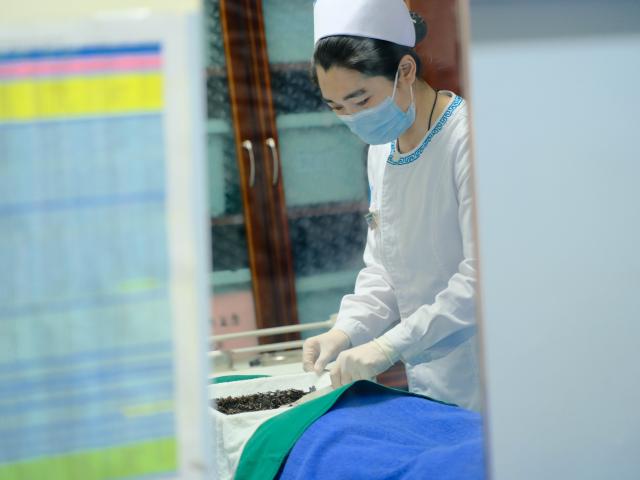 (250512) -- HOHHOT, May 12, 2025 (Xinhua) -- A nurse applies traditional tea and wine therapy of Mongolian medicine to a patient at the International Mongolian Hospital of Inner Mongolia in Hohhot, north China's Inner Mongolia Autonomous Region, May 12, 2025. The nurses of the hospital were busy at their posts on the International Nurse Day. By combining traditional Mongolian medical practices such as tea, wine and moxibustion with contemporary nursing methods, they offer patients nursing services that embodies ethnic medicine characteristics. (Xinhua/Ma Jinrui)