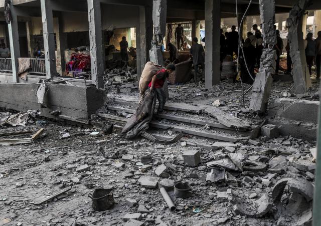 (250512) -- GAZA, May 12, 2025 (Xinhua) -- Palestinians inspect a damaged school after an Israeli airstrike in the Jabalia refugee camp, northern Gaza Strip, May 12, 2025. (Photo by Mahmoud Zaki/Xinhua)