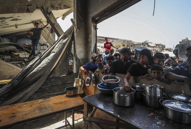 (250512) -- GAZA, May 12, 2025 (Xinhua) -- Palestinians wait to receive free food from a food distribution center in the Jabalia refugee camp, northern Gaza Strip, May 11, 2025. (Photo by Mahmoud Zaki/Xinhua)