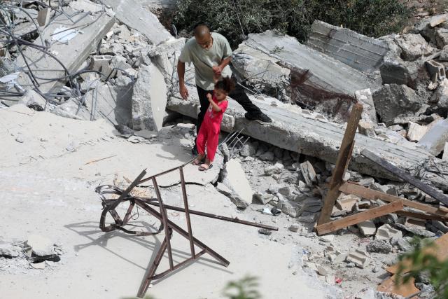 (250512) -- HEBRON, May 12, 2025 (Xinhua) -- Palestinians are seen among rubble after Israeli excavators demolished a house in the village of Idna, west of the West Bank city of Hebron, May 12, 2025. (Photo by Mamoun Wazwaz/Xinhua)