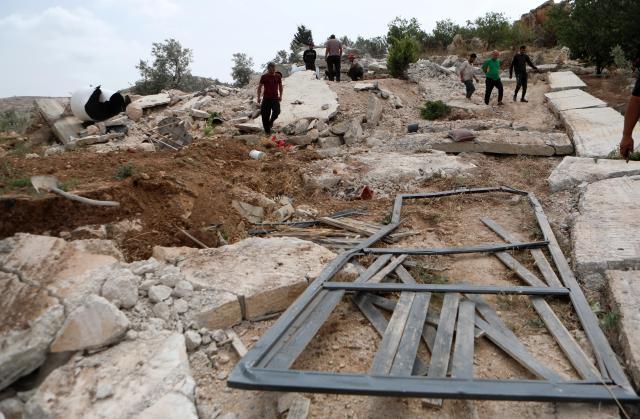(250512) -- HEBRON, May 12, 2025 (Xinhua) -- Palestinians are seen among rubble after Israeli excavators demolished a house in the village of Idna, west of the West Bank city of Hebron, May 12, 2025. (Photo by Mamoun Wazwaz/Xinhua)