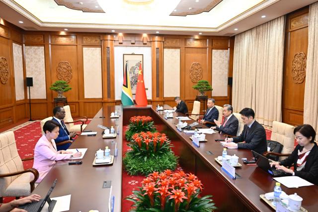 (250512) -- BEIJING, May 12, 2025 (Xinhua) -- Chinese Foreign Minister Wang Yi, also a member of the Political Bureau of the Communist Party of China Central Committee, meets with Hugh Todd, minister of foreign affairs of the Cooperative Republic of Guyana, in Beijing, capital of China, May 12, 2025. (Xinhua/Yue Yuewei)
