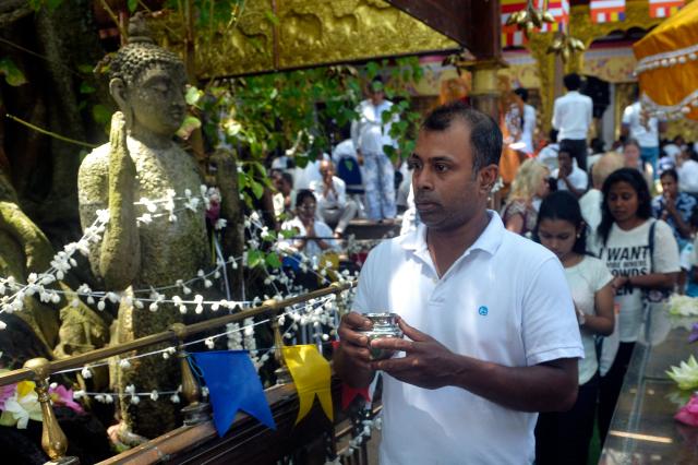 (250512) -- COLOMBO, May 12, 2025 (Xinhua) -- People participate in a celebration of Vesak Day in Colombo, Sri Lanka, on May 12, 2025. (Photo by Gayan Sameera/Xinhua)