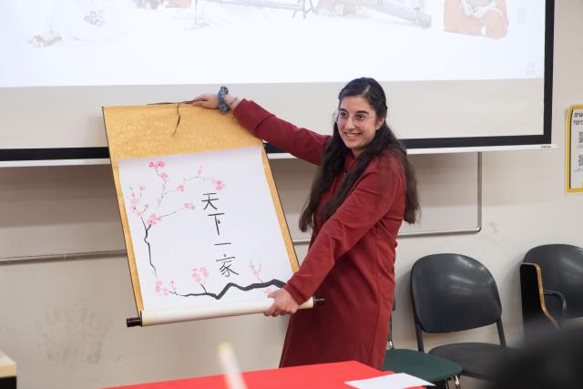 (250529) -- JERUSALEM, May 29, 2025 (Xinhua) -- A participant demonstrates calligraphy during the 24th "Chinese Bridge" Chinese proficiency competition for Israeli university students, in Jerusalem, on May 29, 2025. The 24th "Chinese Bridge" Chinese proficiency competition for Israeli university students concluded in Jerusalem on Thursday, featuring Chinese-language speeches and a variety of talent performances. Alon Shoval from the Hebrew University of Jerusalem won the contest, and will represent Israeli university students to compete in the annual international Chinese language contest to be held in China. (Xinhua/Chen Junqing)