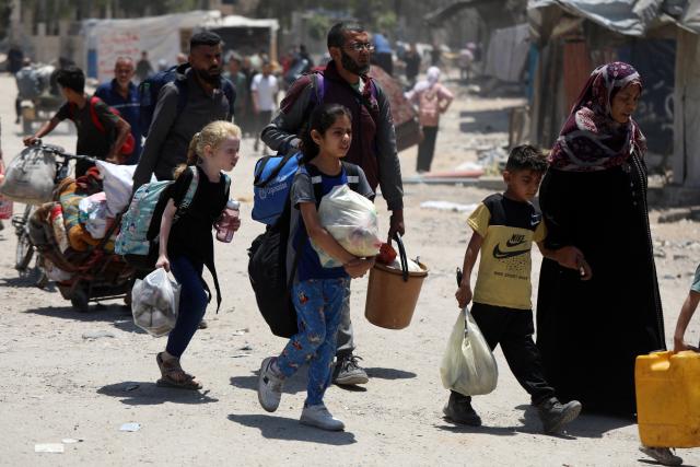(250531) -- GAZA, May 31, 2025 (Xinhua) -- Displaced Palestinians walk on a street in Jabalia refugee camp, as they flee with their belongings from Jabalia area in northern Gaza Strip to central and western Gaza City, on May 30, 2025. (Photo by Rizek Abdeljawad/Xinhua)