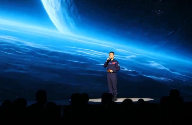 (250531) -- DUNHUANG, May 31, 2025 (Xinhua) -- China's Shenzhou-17 astronaut Tang Shengjie gives a themed demonstration at the opening ceremony of the fourth Dialogue on Exchanges and Mutual Learning among Civilizations in Dunhuang, northwest China's Gansu Province, May 30, 2025. The fourth Dialogue on Exchanges and Mutual Learning among Civilizations kicked off here on Friday. About 400 people attended the meeting, including political leaders, scholars, and heads of international organizations and non-governmental organizations from multiple countries. (Xinhua/Zhang Rui)
