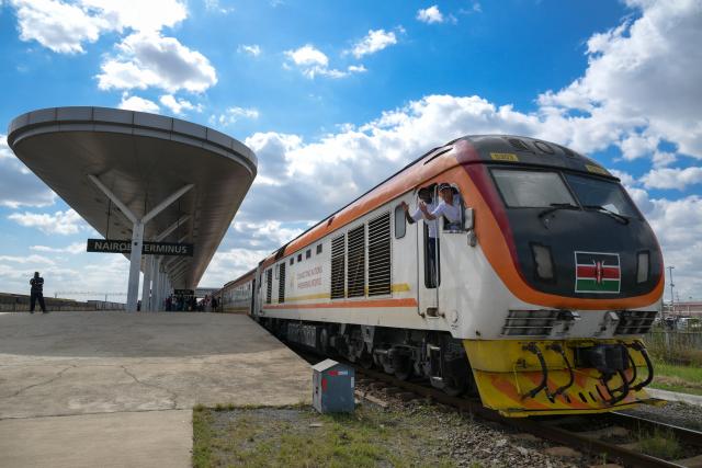 (250601) -- BEIJING, June 1, 2025 (Xinhua) -- Train drivers Jiang Liping (R) and Bor wave aboard a train to Mombasa at Nairobi Terminus Station of the China built Mombasa-Nairobi Standard Gauge Railway (SGR) in Nairobi, Kenya, May 31, 2025.
  The Chinese-built Mombasa-Nairobi Standard Gauge Railway (SGR) has just celebrated its 8th anniversary of safe operation.
  In 2017, the SGR, built and operated by China Road and Bridge Corporation, was officially opened to traffic. As the first railway built since Kenya's independence, it runs 480 km between the capital Nairobi and the port city of Mombasa. Cutting the travel time between the two cities by five hours, it also reduces overall logistics costs by about 40 percent. (Xinhua/Yang Guang)