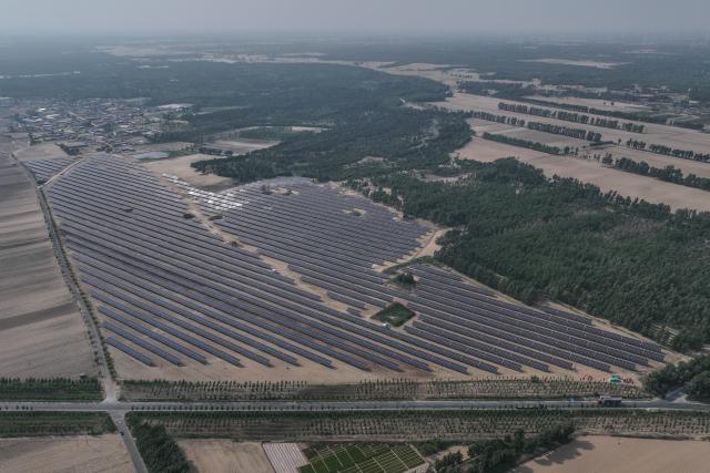 (250601) -- FUXIN, June 1, 2025 (Xinhua) -- An aerial drone photo taken on May 29, 2025 shows a photovoltaic and sand-control project in Zhanggutai Township of Zhangwu County in Fuxin, northeast China's Liaoning Province. Located on the southern edge of the Horqin sandy land, Zhangwu County was once plagued by sand and dust storms. For more than 70 years, people here have made unremitting efforts in transforming the ecological environment of this area to win the tough battle against desertification. The forest coverage rate of Zhangwu has increased from 2.9 percent to more than 30 percent, while the number of dusty days per year has fallen to single digits.
   In recent years, Zhangwu County has promoted its ecological and industrial transformation, and increased local income by developing forestry and under-forest economy. (Xinhua/Pan Yulong)