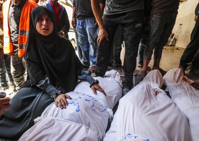 (250602) -- GAZA, June 2, 2025 (Xinhua) -- A Palestinian woman mourns a victim killed in an Israeli airstrike, at the Al-Ahli Arab Hospital in Gaza City, on June 2, 2025. The Israel Defense Forces (IDF) said in a statement on Monday that its troops had expanded ground operations in the Gaza Strip over the past day. In addition, the Israeli Air Force struck dozens of targets across the Gaza Strip since Sunday. (Photo by Mahmoud Zaki/Xinhua)