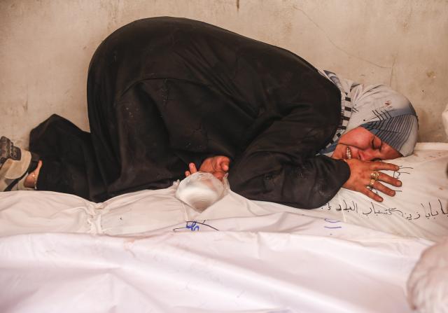 (250602) -- GAZA, June 2, 2025 (Xinhua) -- A Palestinian woman mourns a victim killed in an Israeli airstrike, at the Al-Ahli Arab Hospital in Gaza City, on June 2, 2025. The Israel Defense Forces (IDF) said in a statement on Monday that its troops had expanded ground operations in the Gaza Strip over the past day. In addition, the Israeli Air Force struck dozens of targets across the Gaza Strip since Sunday. (Photo by Mahmoud Zaki/Xinhua)