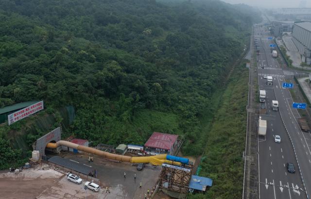 (250603) -- CHONGQING, June 3, 2025 (Xinhua) -- An aerial drone photo taken on June 3, 2025 shows a portal of the Zhongliangshan tunnel, a key project along Chongqing Rail Transit Line 15, in southwest China's Chongqing Municipality. The 4,944-meter Zhongliangshan tunnel, the longest tunnel bored using the mining method in the second phase of Chongqing Rail Transit Line 15, achieved full breakthrough on Tuesday, marking a major progress in the construction of the city's first urban rail express line. (Xinhua/Chen Cheng)