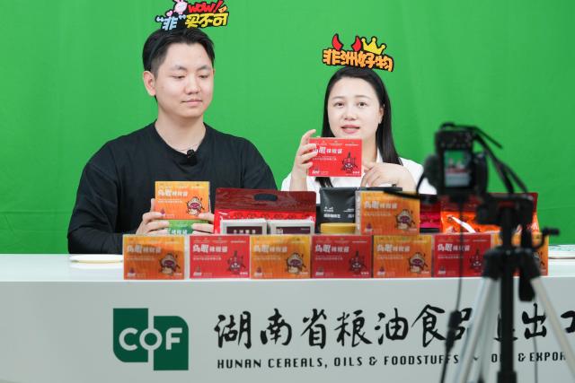 (250613) -- BEIJING, June 13, 2025 (Xinhua) -- Staff members promote Rwandan chili sauce products via live stream at the Hunan Cereals, Oils & Foodstuffs Import & Export Group in central China's Hunan Province, June 5, 2025. At the ongoing 4th China-Africa Economic and Trade Expo held in Changsha of Hunan, a chili sauce product, made from Rwandan peppers, has received great consumer attention for its strong flavor. The rise of the chili sauce is a clear sign of a growing bond between African farms and Chinese consumers. 
  Dating back to the 1st China-Africa Economic and Trade Expo in 2019, enterprises in Hunan made a preliminary agreement with their Rwandan counterparts to purchase dried peppers, following an export application of dried peppers from Rwanda to China. In August 2021, Rwanda exported dried peppers to Hunan for the first time and became the first African country exporting dried peppers to China. 
  In 2024, Gashora Farm, which is headquartered in Kigali, the capital of Rwanda, partnered with HAIC -- Hunan Modern Agriculture International Development Co. Ltd, a subsidiary of Hunan Cereals, Oils & Foodstuffs Import & Export Group (Hunan COF) -- to launch the Rwanda-Hunan Chili Pepper Industry Demonstration Project. Rwanda's favorable climate, affordable labor force, and efficient government procedures facilitated the project's growth. 
   Under a contract farming model, the project covers 100 hectares and spans the entire value chain -- from seedling cultivation to export. In the first season after the deal was signed, 200 tons of dried chili were shipped to China.
  The Rwandan chili project crystalizes deepening Africa-China cooperation. Across the Asian and African continents, stories of trust, cooperation, and shared growth continue to get written. (Xinhua/Chen Zeguo)
