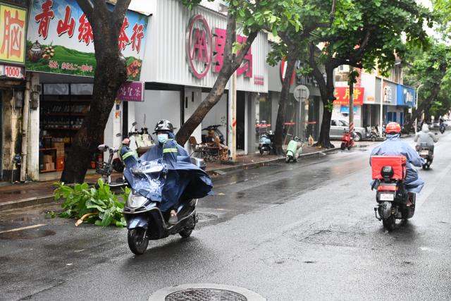 (250614) -- GUANGZHOU, June 14, 2025 (Xinhua) -- People ride on a street in rain in Zhanjiang City, south China's Guangdong Province, June 14, 2025. Typhoon Wutip, the first typhoon of this year, made its second landfall near Leizhou City in south China's Guangdong Province at around 12:30 a.m. Saturday, according to the provincial meteorological observatory. (Xinhua/Xiao Ennan)