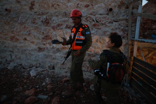 (250616) -- SAFED (ISRAEL), June 16, 2025 (Xinhua) -- Israeli security forces work at the scene of a missile attack in Safed, northern Israel, on June 16, 2025. Several missiles from Iran were fired at Israel on Monday evening, triggering air raid sirens in Haifa and dozens of other cities and communities across northern Israel and the occupied Golan Heights, the Israeli military said. (David Cohen/JINI via Xinhua)