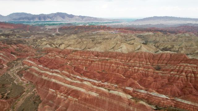 (250623) -- ZHANGYE, June 23, 2025 (Xinhua) -- An aerial drone photo taken on June 22, 2025 shows a view of Danxia landform in the rain at the Danxia National Geological Park in Zhangye, northwest China's Gansu Province. (Xinhua/Chen Bin)