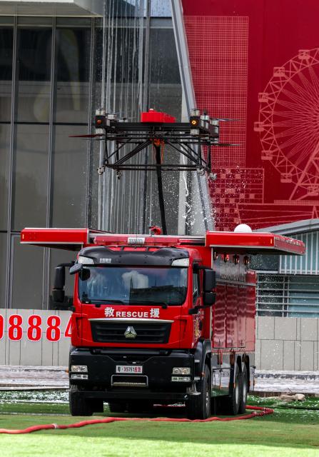 (250625) -- SHENZHEN, June 25, 2025 (Xinhua) -- A fire engine with a drone is parked at the site of a fire drill for a high-rise building in Shenzhen, south China's Guangdong Province, June 24, 2025. A high-rise building fire drill aimed at testing the efficiency of high-tech firefighting methods and improving response time was held here on Tuesday. (Xinhua/Mao Siqian)