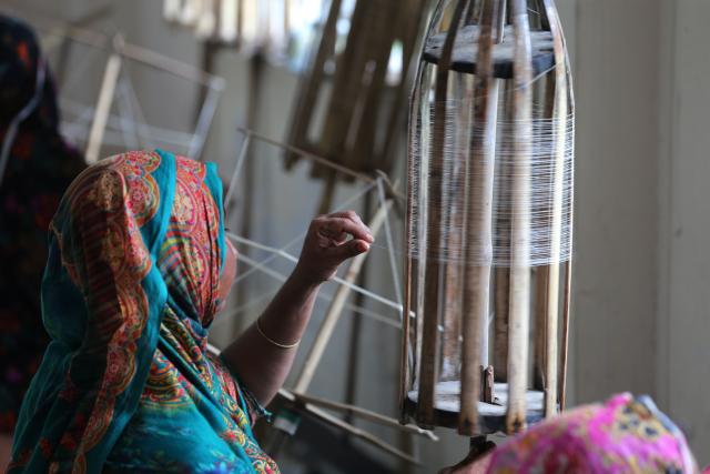 (250625) -- DHAKA, June 25, 2025 (Xinhua) -- A weaver works at a muslin workshop in Dhaka, Bangladesh, on May 24, 2025. Bangladesh is undertaking a national effort to revive its legendary Dhaka muslin fabric, once hailed as "woven air" for its ethereal lightness and intricate craftsmanship during the Mughal era. TO GO WITH "Feature: Bangladesh strives to revive near-extinct Mughal-era muslin fabric" (Photo by Habibur Rahman/Xinhua)