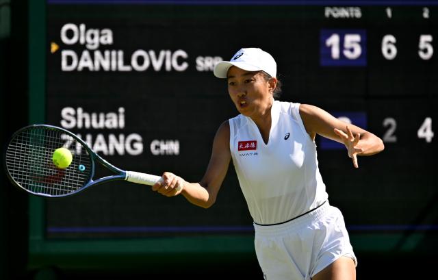 (250701) -- LONDON, July 1, 2025 (Xinhua) -- Zhang Shuai hits a return during the women's singles first round match between Zhang Shuai of China and Olga Danilovic of Serbia at Wimbledon tennis Championship in London, Britain, June 30, 2025. (Xinhua/Li Ying)