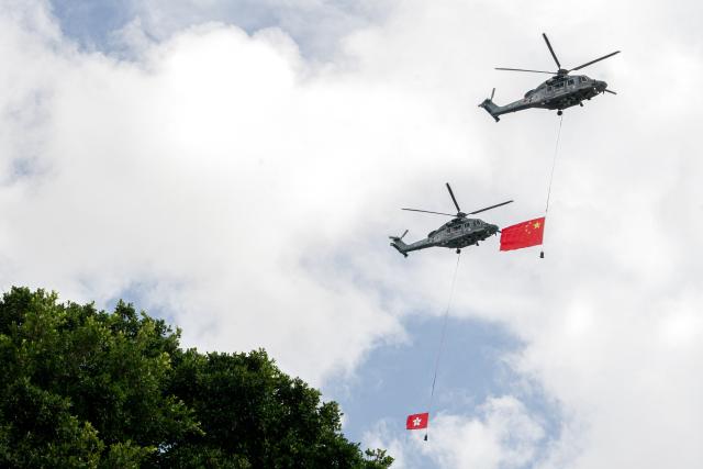 (250701) -- HONG KONG, July 1, 2025 (Xinhua) -- Helicopters carry China's national flag and the flag of the Hong Kong Special Administrative Region (HKSAR) during a flag-raising ceremony held by the HKSAR government to celebrate the 28th anniversary of Hong Kong's return to the motherland in Hong Kong, south China, July 1, 2025. (Xinhua/Lui Siu Wai)