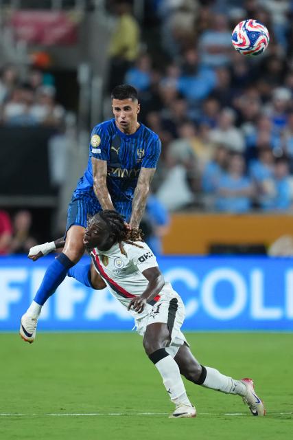 (250701) -- ORLANDO, July 1, 2025 (Xinhua) -- Joao Cancelo (Top) of Al Hilal vies with Jeremy Doku of Manchester City during the round of 16 match between Manchester City of England and Al Hilal of Saudi Arabia at the FIFA Club World Cup 2025 at the Camping World Stadium, Orlando, Florida, the United States, June 30, 2025. (Xinhua/Xu Chang)