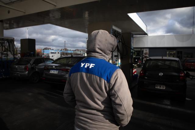 (250701) -- BUENOS AIRES, July 1, 2025 (Xinhua) -- A staff member works at a YPF gas station in Buenos Aires, Argentina, on June 30, 2025. Argentina will appeal the ruling of a court in New York that ordered the South American country to transfer 51 percent of the shares of the national oil and gas company YPF, said President Javier Milei Monday.
   The U.S. district judge agreed earlier Monday to the request of the plaintiffs to seize YPF shares, after a 2023 ruling that ordered cash-strapped Argentina to pay them about 16.1 billion U.S. dollars. (Photo by Martin Zabala/Xinhua)