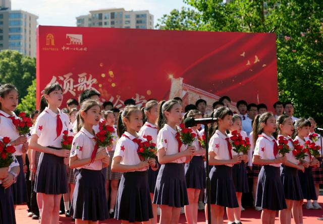 (250701) -- SHANGHAI, July 1, 2025 (Xinhua) -- Students chorus in front of the memorial of the First National Congress of the Communist Party of China in Shanghai, east China, July 1, 2025. A series of events celebrating the 104th founding anniversary of the Communist Party of China (CPC) were held at the memorial of the First National Congress of the CPC on Tuesday. (Xinhua/Liu Ying)