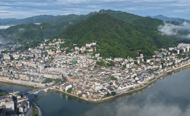 (250701) -- HUAIHUA, July 1, 2025 (Xinhua) -- An aerial drone photo taken on July 1, 2025 shows a view of Huaihua City, central China's Hunan Province. Huaihua is the province's node city along the New International Land-Sea Trade Corridor and a freight assembly center for ASEAN countries. (Photo by Li Gang/Xinhua)