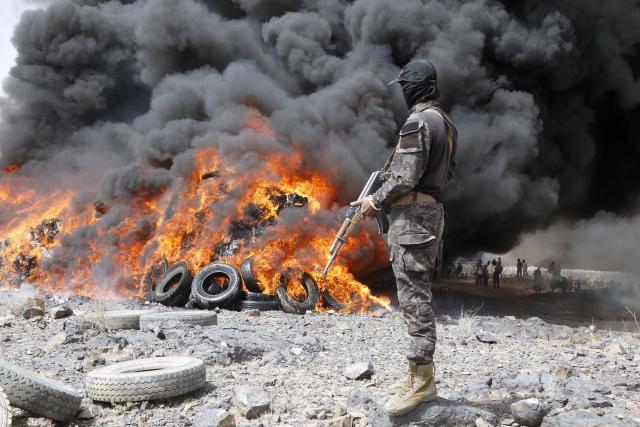 (250702) -- SANAA, July 2, 2025 (Xinhua) -- A soldier stands guard as illicit narcotics are being burned near Sanaa, Yemen, on July 1, 2025.
  Security forces of Yemen's Houthi group destroyed approximately 19 tons of narcotics, hashish and other illegal drugs here on Tuesday. (Photo by Mohammed Mohammed/Xinhua)