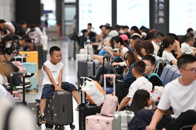 (250702) -- BEIJING, July 2, 2025 (Xinhua) -- Passengers wait for trains in Tianjin West Railway Station in north China's Tianjin Municipality, July 1, 2025. A new train schedule took effect in China on July 1, 2025, starting this year's 62-day summer travel season, according to the railway operator. (Xinhua/Li Ran)