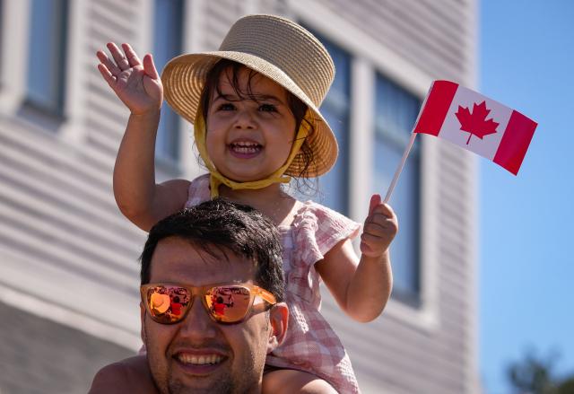 (250702) -- BEIJING, July 2, 2025 (Xinhua) -- A girl holds a flag during a Canada Day parade in Richmond, British Columbia, Canada, on July 1, 2025. (Photo by Liang Sen/Xinhua)