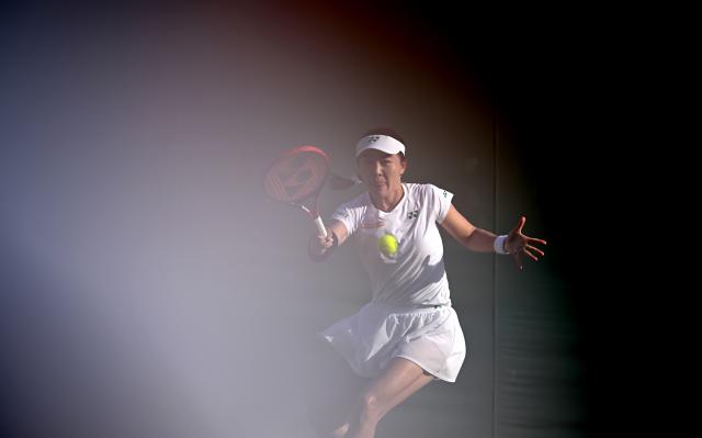 (250702) -- LONDON, July 2, 2025 (Xinhua) -- Zhu Lin hits a return during the women's singles first round match between Zhu Lin of China and Veronika Kudermetova of Russia at the Wimbledon Tennis Championships in London, Britain, July 1, 2025. (Xinhua/Li Ying)