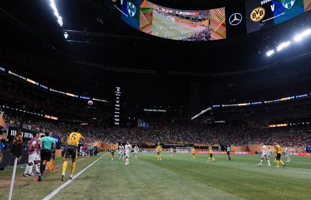 (250702) -- ATLANTA, July 2, 2025 (Xinhua) -- Borussia Dortmund's Ramy Bensebaini (R, front) takes a throw-in during the round of 16 match between Borussia Dortmund of Germany and CF Monterrey of Mexico at the FIFA Club World Cup 2025 at the Mercedes-Benz Stadium, Atlanta, Georgia, the United States, July 1, 2025. (Xinhua/Huang Zongzhi)