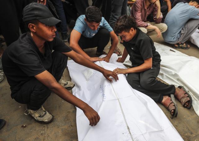 (250702) -- GAZA CITY, July 2, 2025 (Xinhua) -- Palestinians mourn over victims who were killed in Israeli airstrikes, at a hospital in Gaza City, July 1, 2025. At least 45 Palestinians were killed by Israeli shelling and gunfire in the Gaza Strip on Tuesday, Gaza's Civil Defense said, while the Israeli army announced that it had attacked 140 targets in the coastal enclave over the past 24 hours. (Photo by Mahmoud Zaki/Xinhua)