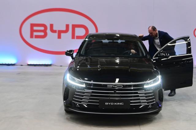 (250702) -- BAHIA, July 2, 2025 (Xinhua) -- Guests take a close look at a BYD new energy vehicle on display in Camacari, Bahia State, Brazil, July 1, 2025. Chinese automaker BYD held a ceremony marking its first Brazil-made passenger vehicle rolling off the line at its factory in Camacari on Tuesday. (Photo by Lucio Tavora/Xinhua)