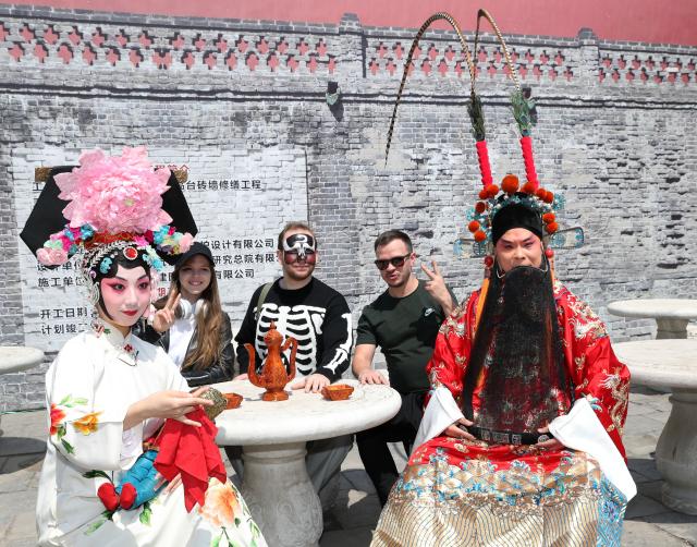(250702) -- SHENYANG, July 2, 2025 (Xinhua) -- Russian tourists experience the makeup of Peking Opera at Shenyang Palace Museum in Shenyang, northeast China's Liaoning Province, April 30, 2024. In recent years, Liaoning Province has actively built a facilitation system for cross-border cultural and tourism exchanges. It has participated in international tourism promotion activities, striving to enhance the quality of foreign-related tourism services and promote the high-quality development of inbound tourism. (Xinhua/Li Gang)