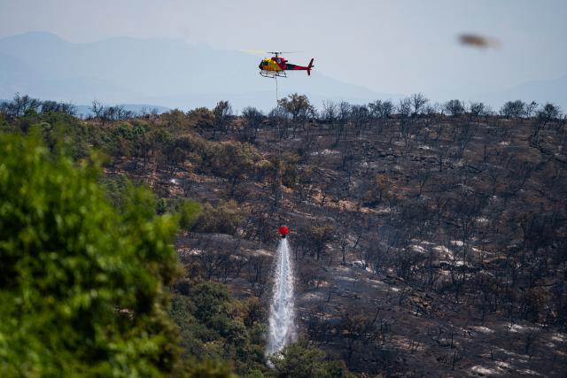 (250702) -- LLEIDA, July 2, 2025 (Xinhua) -- A firefighting plane extinguishes the flame in Lleida province, Spain, July 2, 2025. Two farmers were killed in a wildfire that burned through 5,000 hectares in the La Segarra district of Lleida province, north-east Spain, on Tuesday, according to local emergency services. (Photo by Joan Gosa/Xinhua)