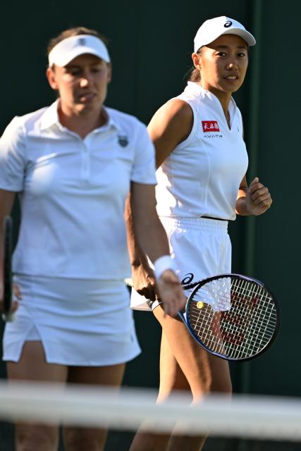(250703) -- LONDON, July 3, 2025 (Xinhua) -- Zhang Shuai (R)/Ekaterina Alexandrova react during the women's doubles first round match between Zhang Shuai (China)/Ekaterina Alexandrova (Russia) and Yuliia Starodubtseva/Nadiia Kichenok of Ukraine at the Wimbledon Tennis Championships in London, Britain, July 2, 2025. (Xinhua/Zhao Dingzhe)
