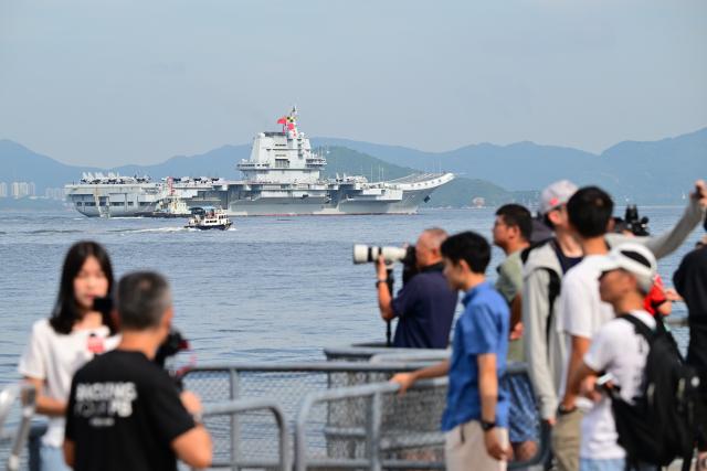 (250703) -- HONG KONG, July 3, 2025 (Xinhua) -- This photo shows the aircraft carrier Shandong sailing in Hong Kong waters, south China, July 3, 2025. A fleet of the Chinese People's Liberation Army Navy led by the aircraft carrier Shandong arrived in the Hong Kong Special Administrative Region on Thursday morning. (Xinhua/Zhu Wei)
