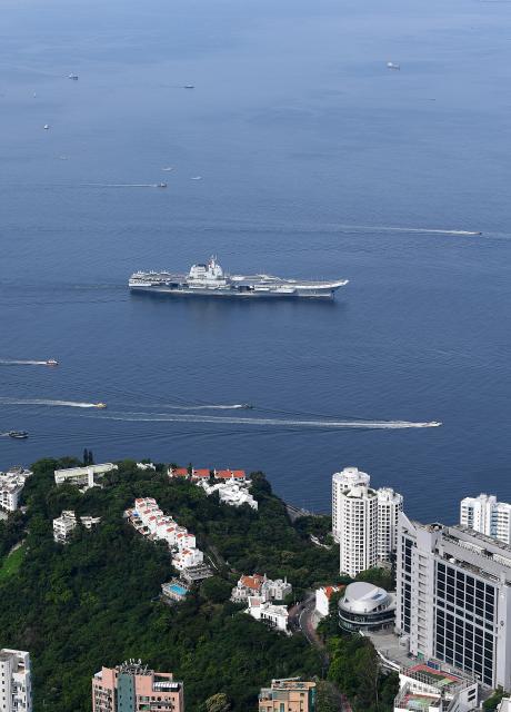 (250703) -- HONG KONG, July 3, 2025 (Xinhua) -- This photo shows the aircraft carrier Shandong sailing in Hong Kong waters, south China, July 3, 2025. A fleet of the Chinese People's Liberation Army (PLA) Navy led by the aircraft carrier Shandong arrived in the Hong Kong Special Administrative Region (HKSAR) on Thursday morning, kicking off a five-day visit.
   The aircraft carrier and the Yan'an missile destroyer were anchored near the west end of the Victoria Harbor, while the Zhanjiang missile destroyer and the Yuncheng missile frigate docked at the PLA Hong Kong Garrison's naval base in Stonecutters Island.
   This is the Shandong's first visit to Hong Kong. From Friday to Sunday, the Shandong, the Zhanjiang and the Yuncheng will host open tours, lectures, drill demonstrations and other exchange activities. (Xinhua/Chen Duo)