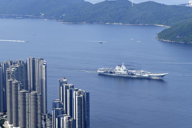(250703) -- HONG KONG, July 3, 2025 (Xinhua) -- This photo shows the aircraft carrier Shandong sailing in Hong Kong waters, south China, July 3, 2025. A fleet of the Chinese People's Liberation Army (PLA) Navy led by the aircraft carrier Shandong arrived in the Hong Kong Special Administrative Region (HKSAR) on Thursday morning, kicking off a five-day visit.
   The aircraft carrier and the Yan'an missile destroyer were anchored near the west end of the Victoria Harbor, while the Zhanjiang missile destroyer and the Yuncheng missile frigate docked at the PLA Hong Kong Garrison's naval base in Stonecutters Island.
   This is the Shandong's first visit to Hong Kong. From Friday to Sunday, the Shandong, the Zhanjiang and the Yuncheng will host open tours, lectures, drill demonstrations and other exchange activities. (Xinhua/Chen Duo)